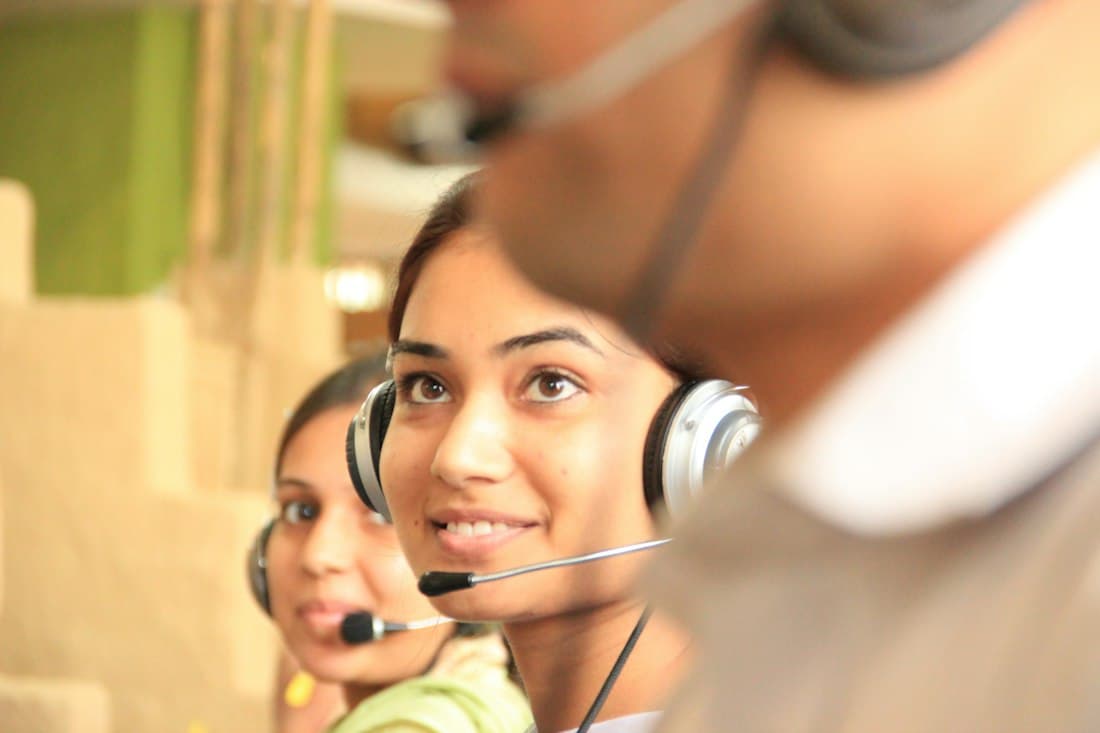 Two interpreters working in headsets in a bright office