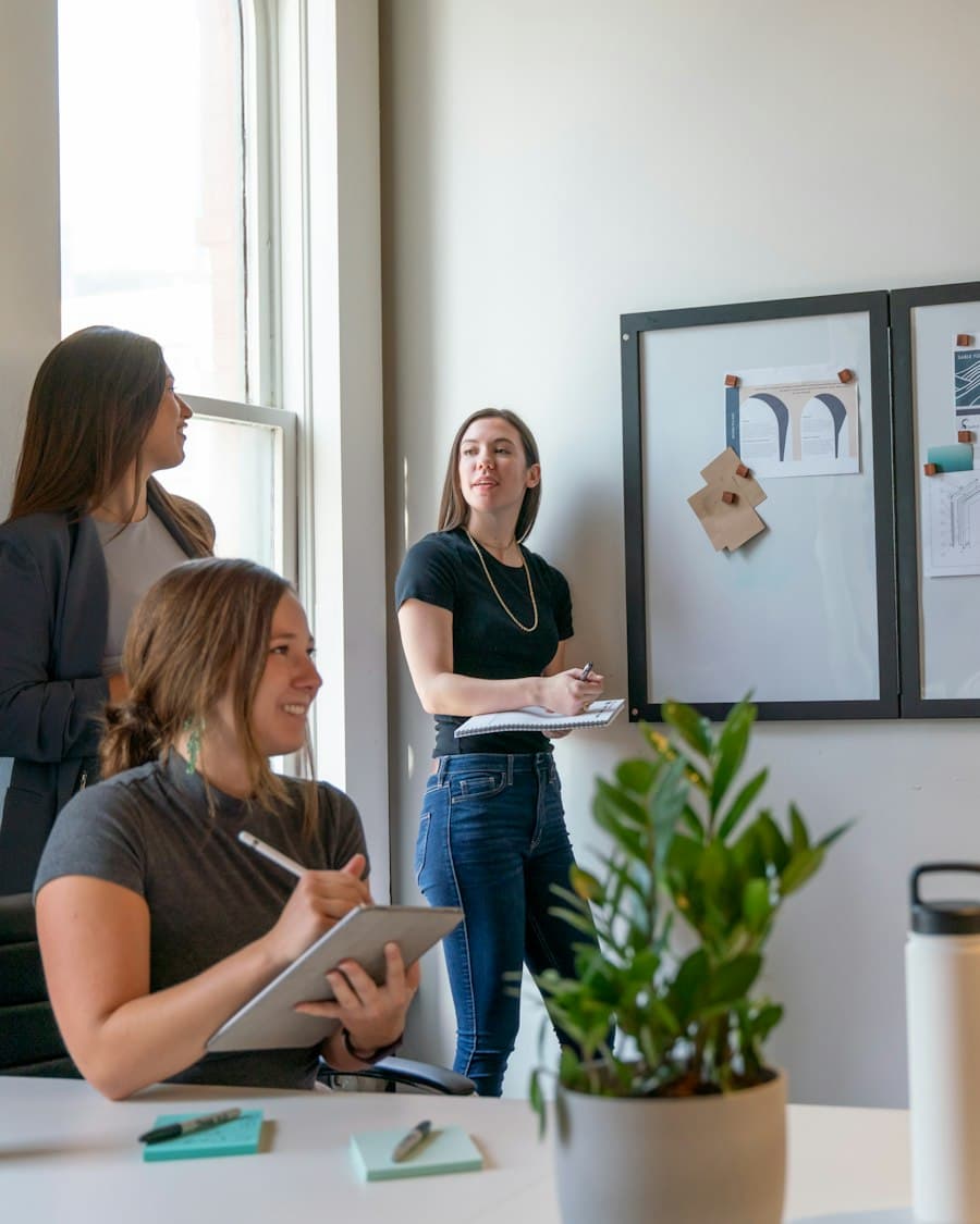 Colleagues working together in a daylit open office